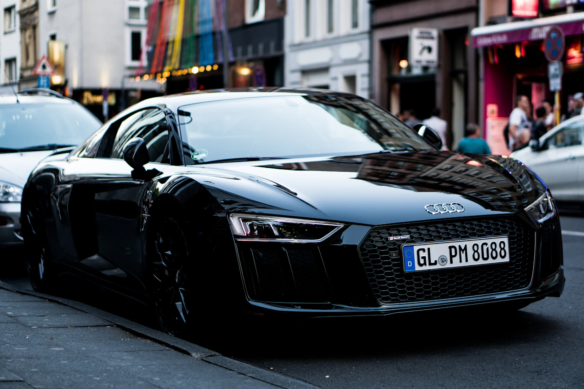 Black Audi performance car in a street setting; illustrative stock photograph